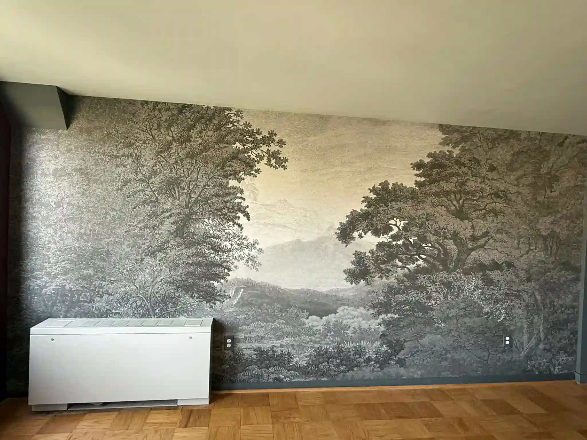 Large tree-and-landscape mural across a room wall